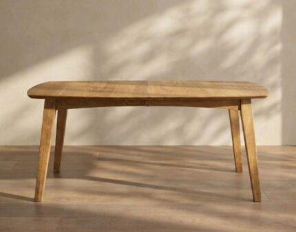 The Burbank Leg Table features a solid wood frame with gently tapered legs and a smooth, rounded top, perfect for any dining space.