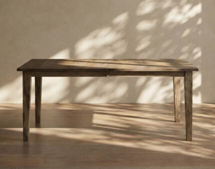 The Beaverton Leg Table features a sturdy, solid wood construction with four tapered legs supporting a rectangular top.