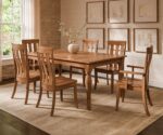The Amish Colby Leg Table Set is a solid wood dining table with a smooth top and four turned legs, providing a sturdy foundation for meals.