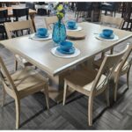 This handcrafted solid wood Alcoe Double Pedestal Table and North Star Chairs set features sleek, modern dining lines.
