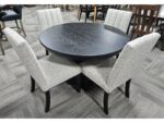 This clearance Brogan Table and Wittenburg Chairs set features a round top with four sleek, upholstered dining chairs.